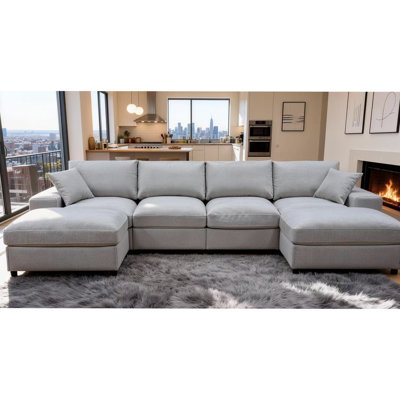 Canapé modulaire avec deux repose-pieds et coussins décoratifs