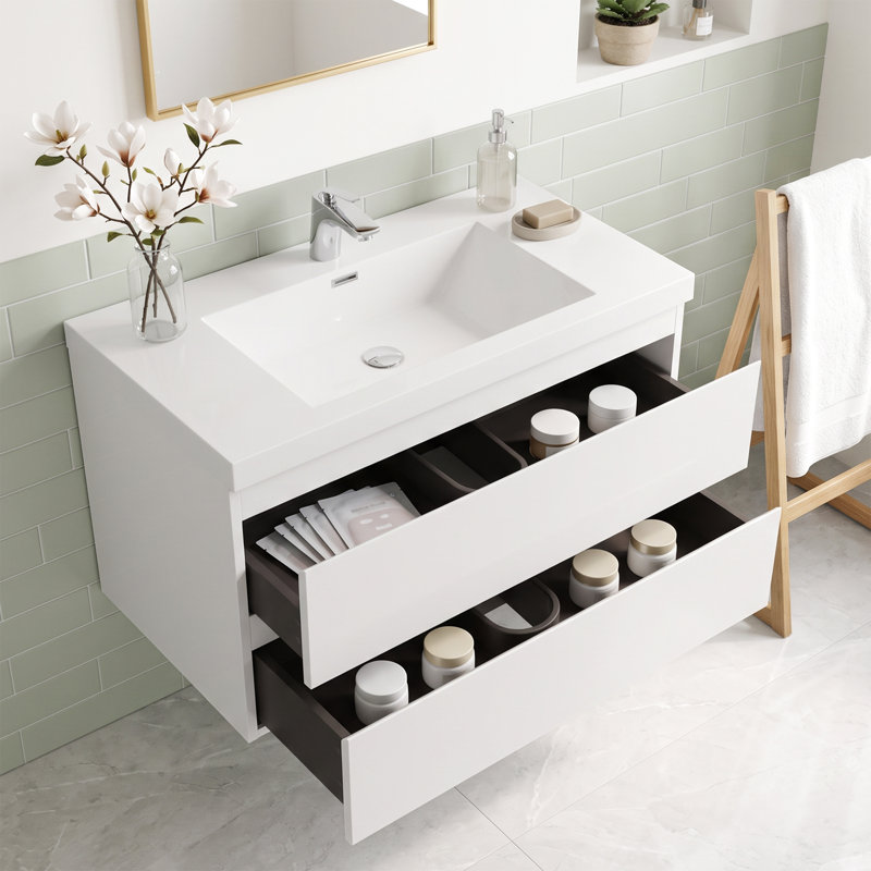 Meuble-lavabo mural de 91 cm (36 po) en panneaux de particules mélaminés blancs avec dessus en résine blanche et carbonate de calcium, deux tiroirs coulissants en forme de U à fermeture amortie, préassemblé.