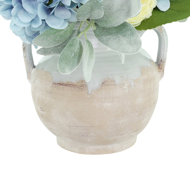 Hortensias et renoncules dans un pot en céramique émaillée