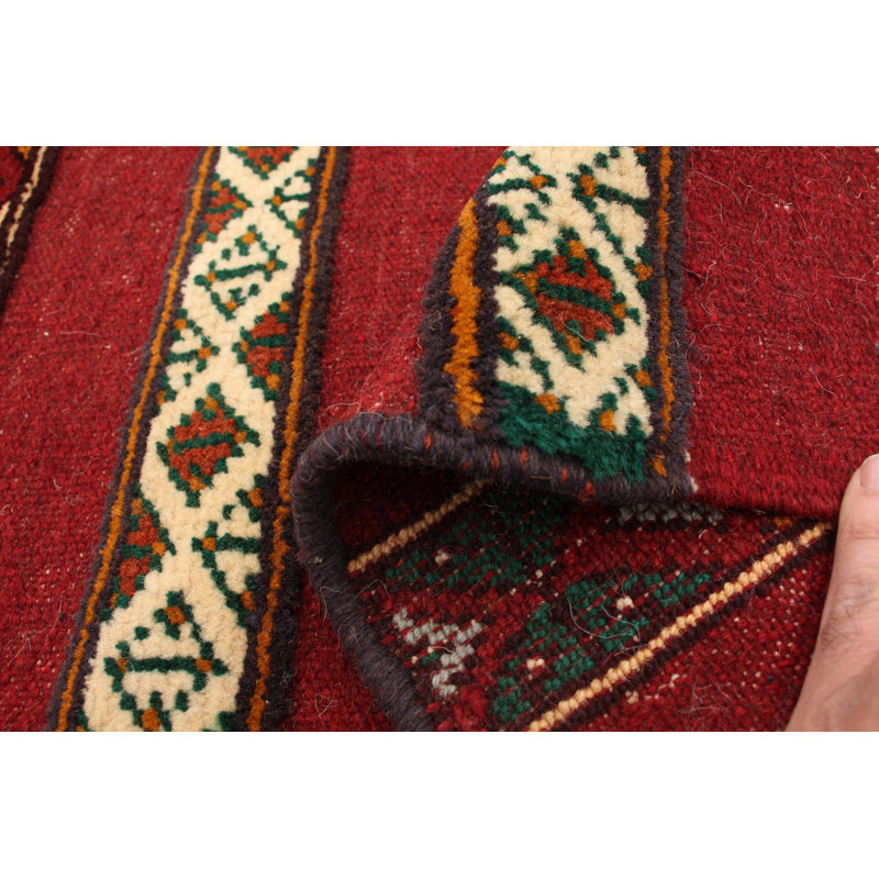 Tapis rouge foncé en laine noué à la main