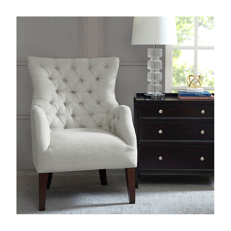 Fauteuil à oreilles capitonné