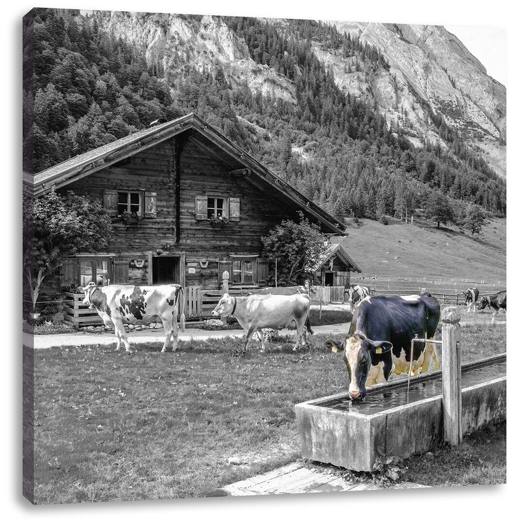 Leinwandbild Kühe vor der Blockhütte auf der Alm