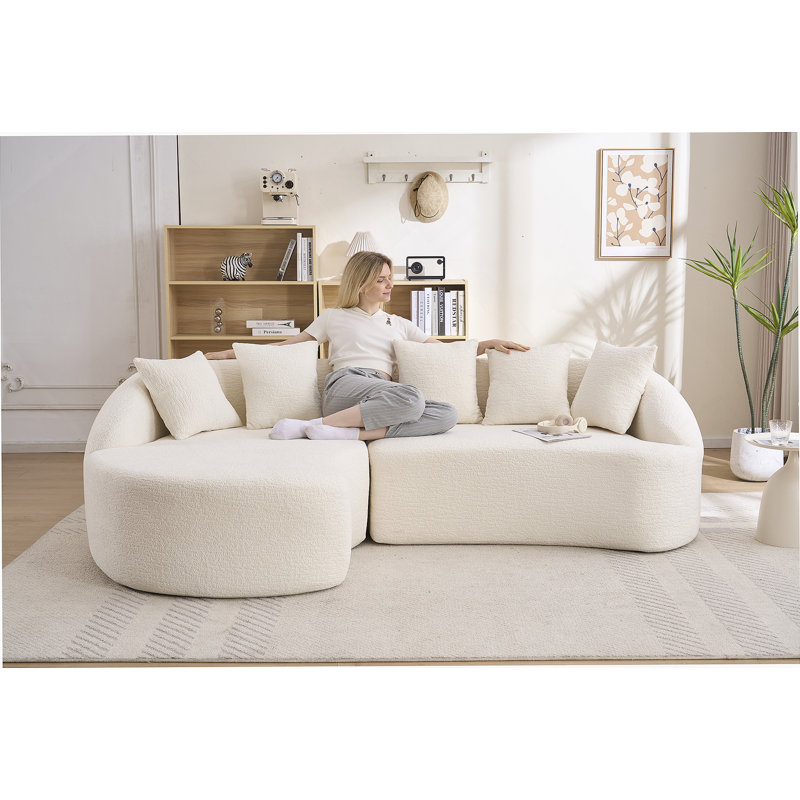 Canapé modulaire en forme de L Boneless avec méridienne incurvée et mousse haute densité pour un confort ultime et une flexibilité modulaire.