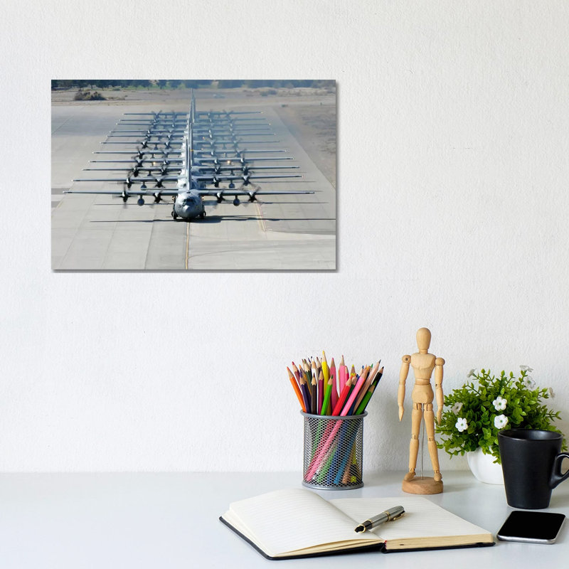 A Line Of C-130 Hercules Taxi At Nellis Air Force Base, Nevada by Stocktrek Images - Wrapped Canvas Print