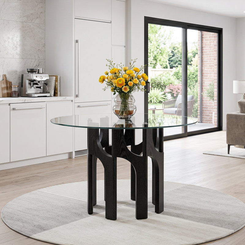 Table de salle à manger ronde de style moderne du milieu du siècle, en verre trempé de 117 cm (46 po), avec un piètement sculptural arqué en MDF à grain de bois.