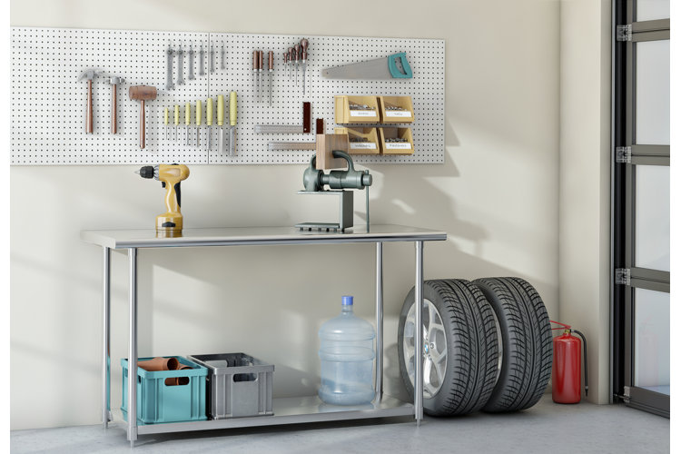 a garage with a metal workbench for powertools with a pegboard on the wall behind it