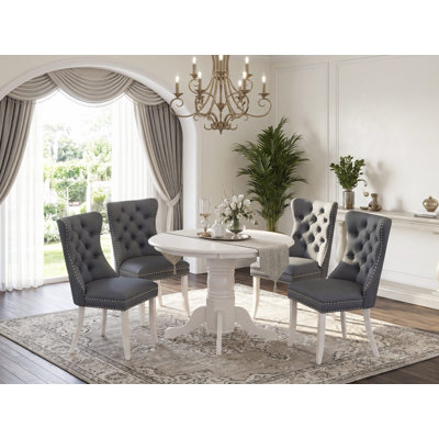 L'ensemble de cuisine 5 pièces comprend une table ronde avec piédestal et 4 chaises rembourrées Parson