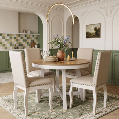 Ensemble de salle à manger rond extensible cinq pièces avec des chaises rembourrées