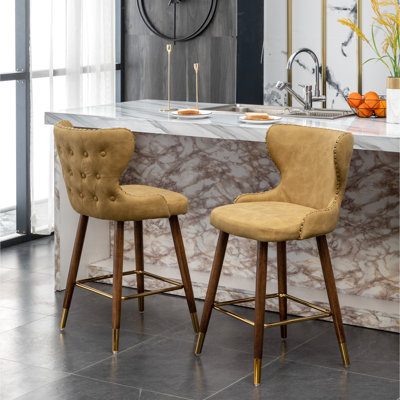 Mid-Century Modern Counter Stool In Yellow - Curved Seat Back, Fabric Upholstery, Walnut Legs Mid-Century Style 2 Pieces Faux Leather Seat, Suede-Like Fabric, Tapered Legs, Gold Metal Footrest