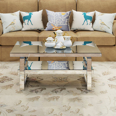 Table basse de luxe avec plateau en verre trempé miroir, 2 compartiments de rangement, matériaux de haute qualité, idéale pour les petits appartements et les salons. Table artisanale moderne avec plateau, fini argenté et design intuitif.