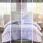 Édredon lavande avec pompons colorés et coussin décoratif en forme de cœur