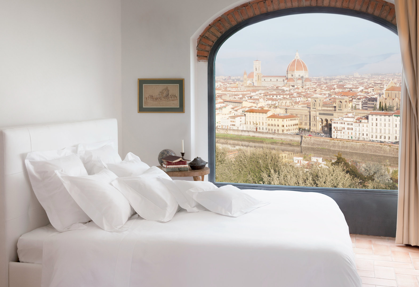 Bedroom with white linens overlooking the Duomo of Florence.