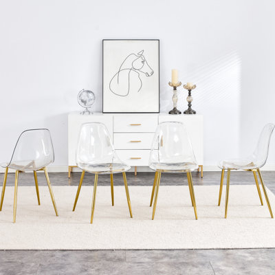 Chaise moderne et transparente, ergonomique avec des éléments en métal doré, polyvalente pour différents environnements et occasions Cadre doré ergonomique, idéale pour des espaces multiples