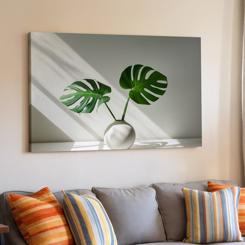 "Toile", une composition minimaliste mettant en vedette deux feuilles de Monstera vertes vibrantes, art mural sur toile en céramique blanche