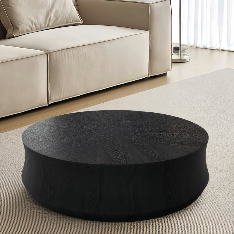 Table basse ronde noire avec un grand tiroir
