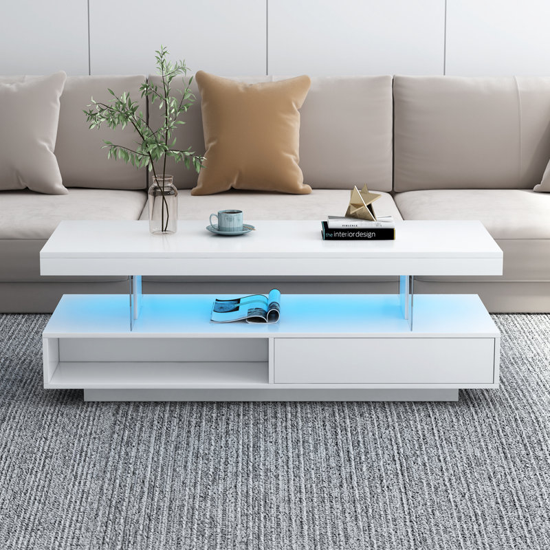 Table basse à DEL avec rangement en blanc: décor de salon. 16 choix de couleurs, luminosité personnalisable. Rangement spacieux. Conception. Table blanche à installation simple: 2 tiroirs, tablettes de présentation, couleurs