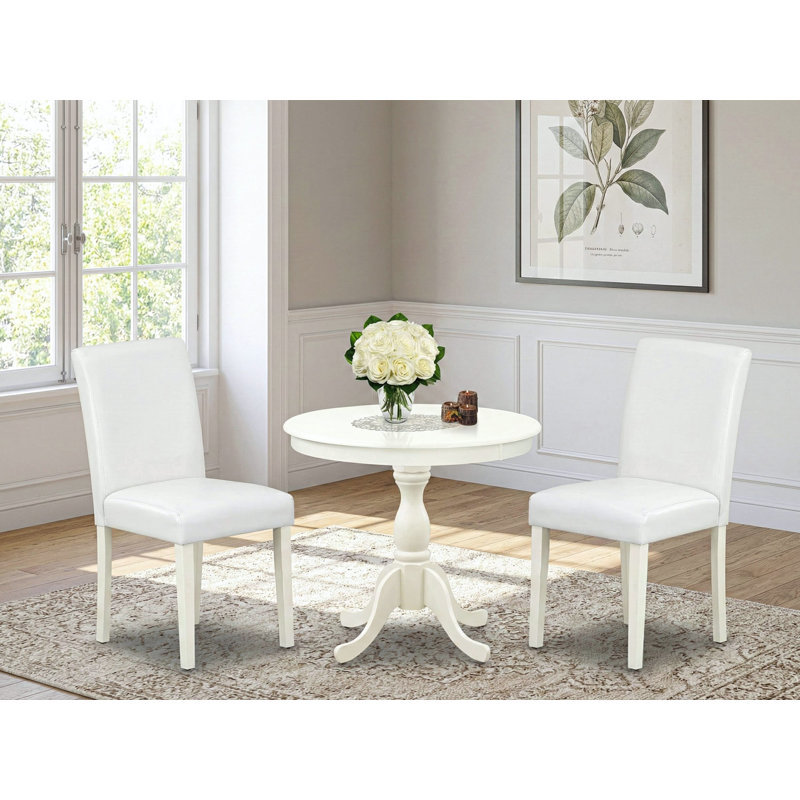 3 Piece Dining Room Furniture Set Contains a Round Kitchen Table with Pedestal and 2 White Faux Leather Parsons Dining Chairs, Linen White