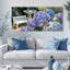 Tableau sur toile tendue représentant un jardin d'hortensias avec banc blanc et papillon (lot de 3)-475839022