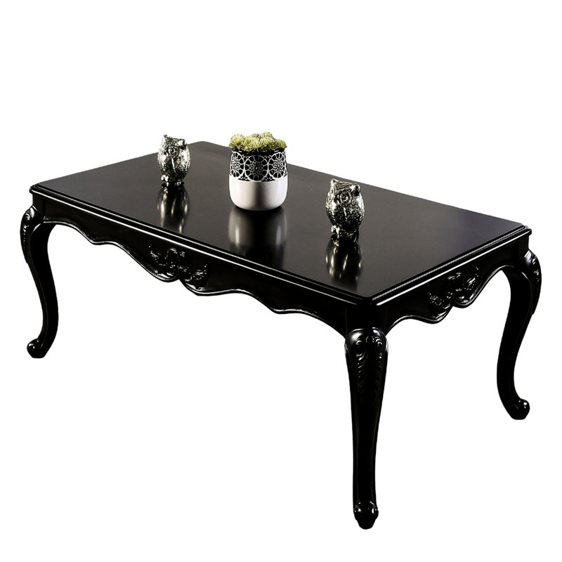 / finition noire, table basse rectangulaire traditionnelle, structure en bois massif, pieds courbés, détails décoratifs, pieds
