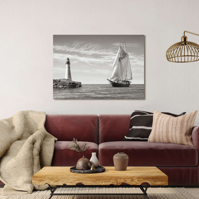 Photograph Of A Sailboat Approaching Lighthouse, Mediterranean Sea by Pangea Images - Print