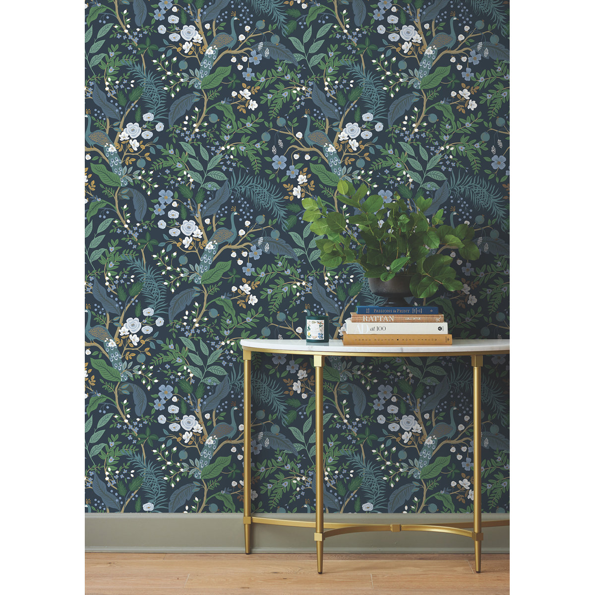 Blue floral wallpaper on a wall with a white and gold table in front of it
