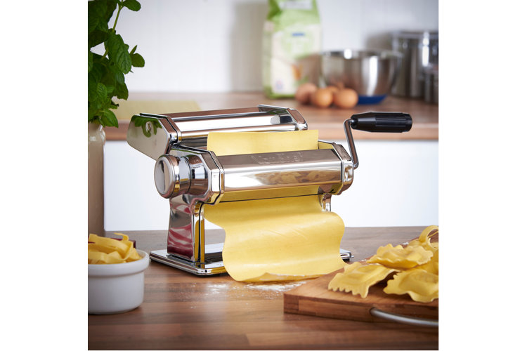 pasta maker processing a sheet of pasta dough