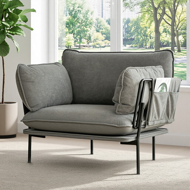Fauteuil épais avec tissu doux, structure en métal robuste, coussins et poches latérales