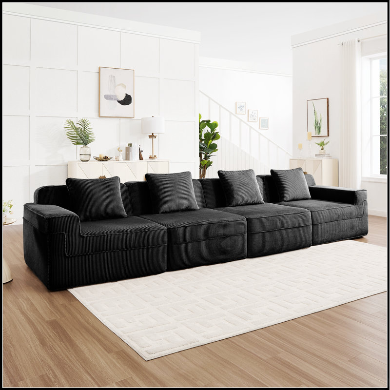 Canapé d'angle modulaire quatre places Cloud sans ossature, avec assises profondes et revêtement en velours côtelé pour une détente optimale.