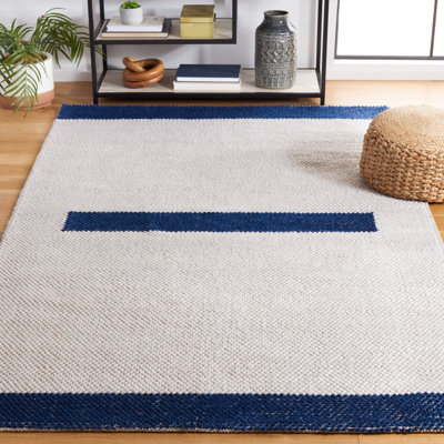 Tapis ivoire / bleu marine en laine tissé à la machine