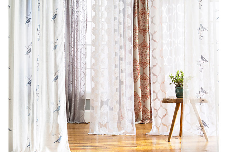 Multiple white patterned curtains