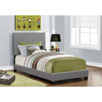 Lit simple gris avec rembourrage en mousse confortable pour une chambre à coucher