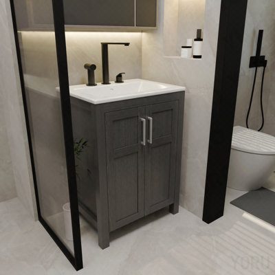 Une armoire de salle de bain noire de 24 pouces, jumelée à un lavabo en céramique blanche, présente un design moderne et est faite de matériaux imperméables et durables.
