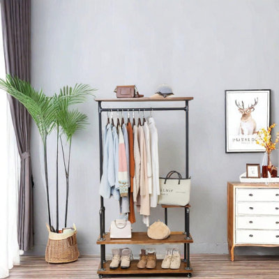 Industrial Clothing Rack - A Pipe Style Rolling Garment Rack With A Heavy-Duty Steampunk Design. This Hall Tree On Wheels Features Rustic Wood And Comes With A Shelf And Shoes Storage, Perfect For Home Or Retail Store Use.