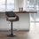 Afshar Swivel Adjustable Height Bar Stool with Pedestal Base in Faux Leather, Wood and Iron