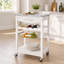 Chariot d'îlot de cuisine mobile en métal blanc, comptoir en marbre avec tiroirs et paniers en métal coulissants, chariot de rangement multifonctionnel avec roulettes.