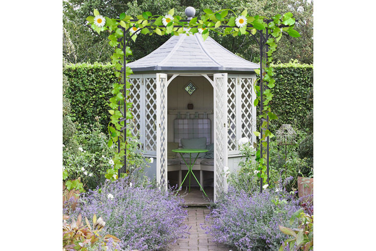 White garden gazebo with seating and a green garden stool.
