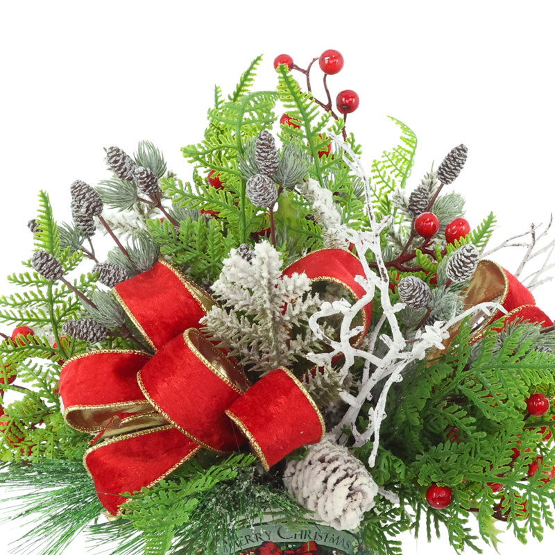 Festive holiday arrangement with greens and Berries