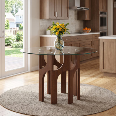Table de salle à manger ronde de style moderne du milieu du siècle, en verre trempé de 117 cm (46 po), avec un piètement sculptural arqué en MDF à grain de bois.