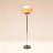 A Bauhaus-style egg tart-shaped iron and glass floor lamp