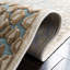 Banerjee Animal Print Area Rug in Stone/Aqua-778425403