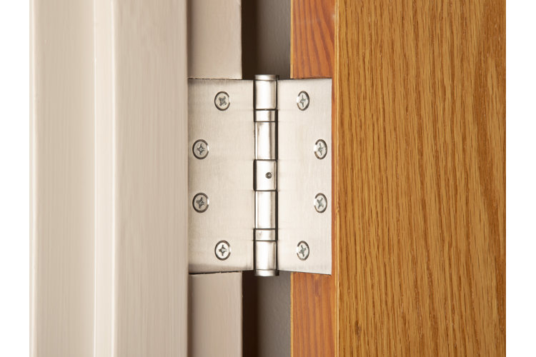closeup of a chrome door hinge in the open position