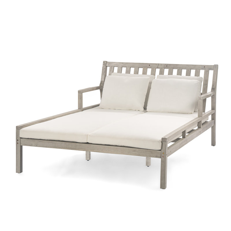 Chaise longue d'extérieur en bois avec accoudoirs confortables et quatre coussins pour la détente