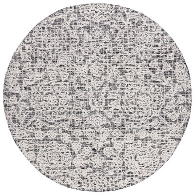 Caniah Hand Tufted Wool/Viscose/Cotton Floral Rug in Black/Ivory