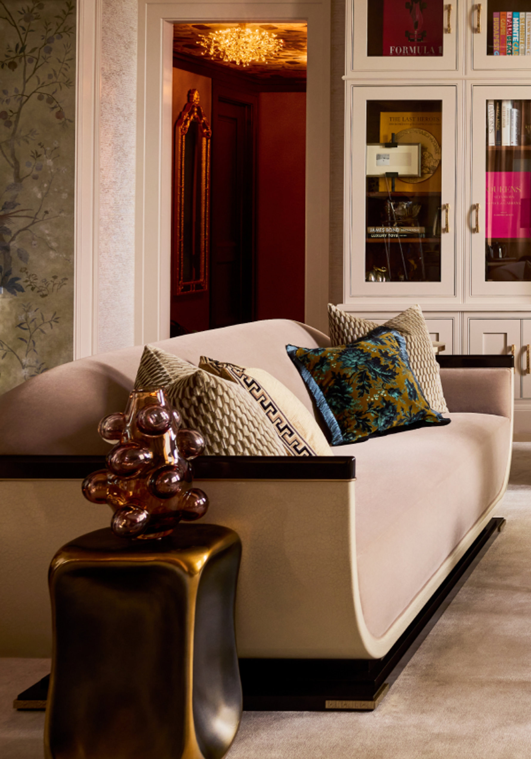 Upholstered sofa with a decorative vase and pillows.