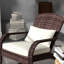 Fauteuil à bascule blanc crème pour balcon, avec dossier haut, coussin d'assise confortable et oreiller, idéal pour se détendre sur une terrasse, dans un jardin ou sur un porche.