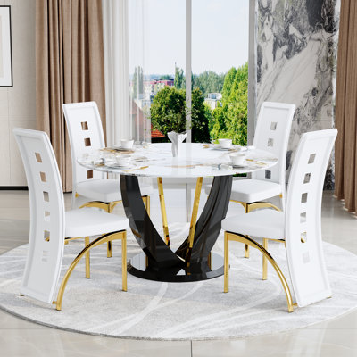 Ensemble de salle à manger rond noir et doré avec plateau en faux marbre et chaises en similicuir