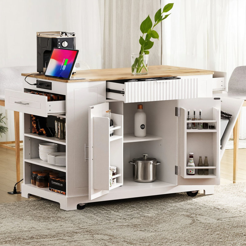 The Kitchen Island With Slots Is A 5-Wheel Rolling Unit And Includes Trash Can Storage, Electrical Outlets, Interior Storage Shelves, 3 Drawers, And 3 Open Side Shelves That Accommodate 10-Gallon Trash Cans.