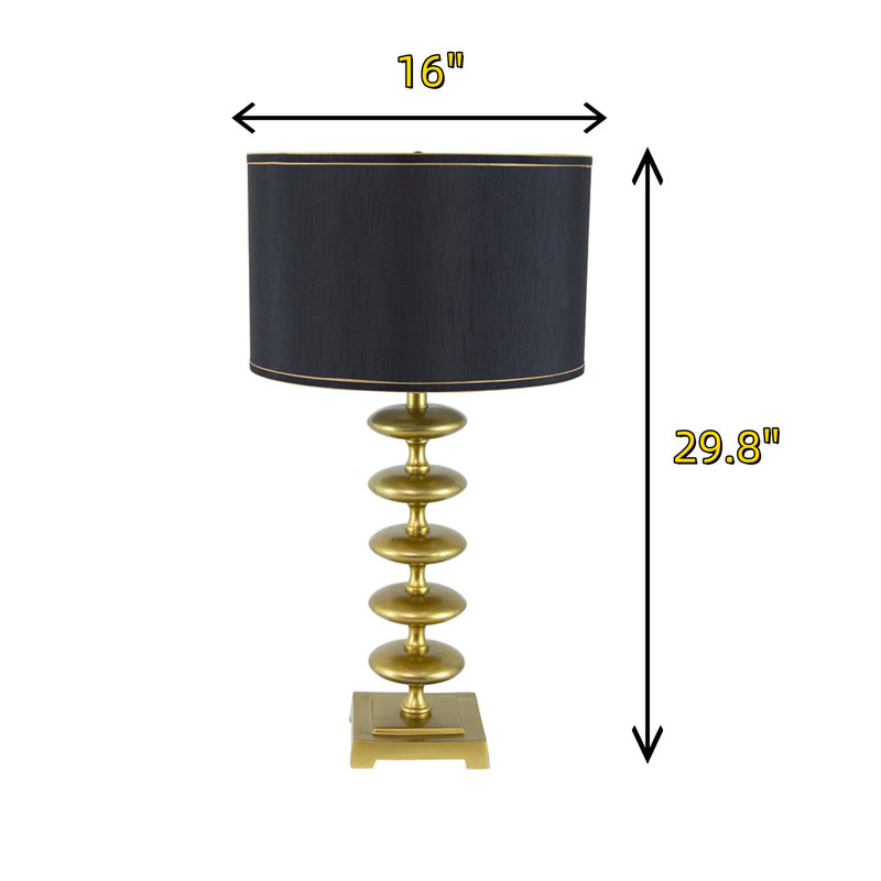Dotée d'un design moderne en forme de disque, cette lampe de table noire