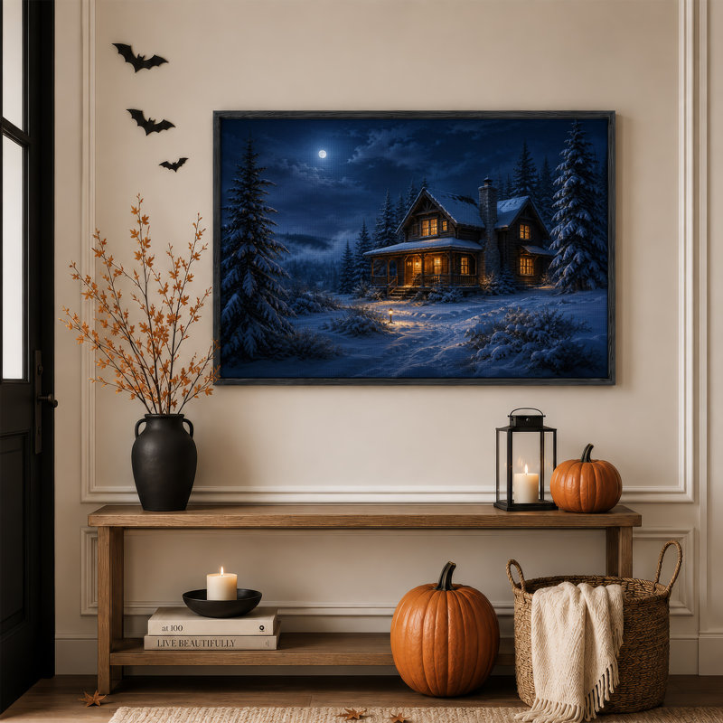 Cabane en bois rond enneigée aux fenêtres illuminées sous une toile murale d'Halloween, 18"H x 24"W