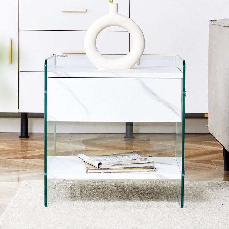 Table de chevet avec tiroirs. La surface de la planche est un autocollant en panneau de fibres à densité moyenne et les deux côtés sont en verre trempé transparent.